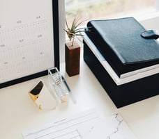 desk with notebooks and pens