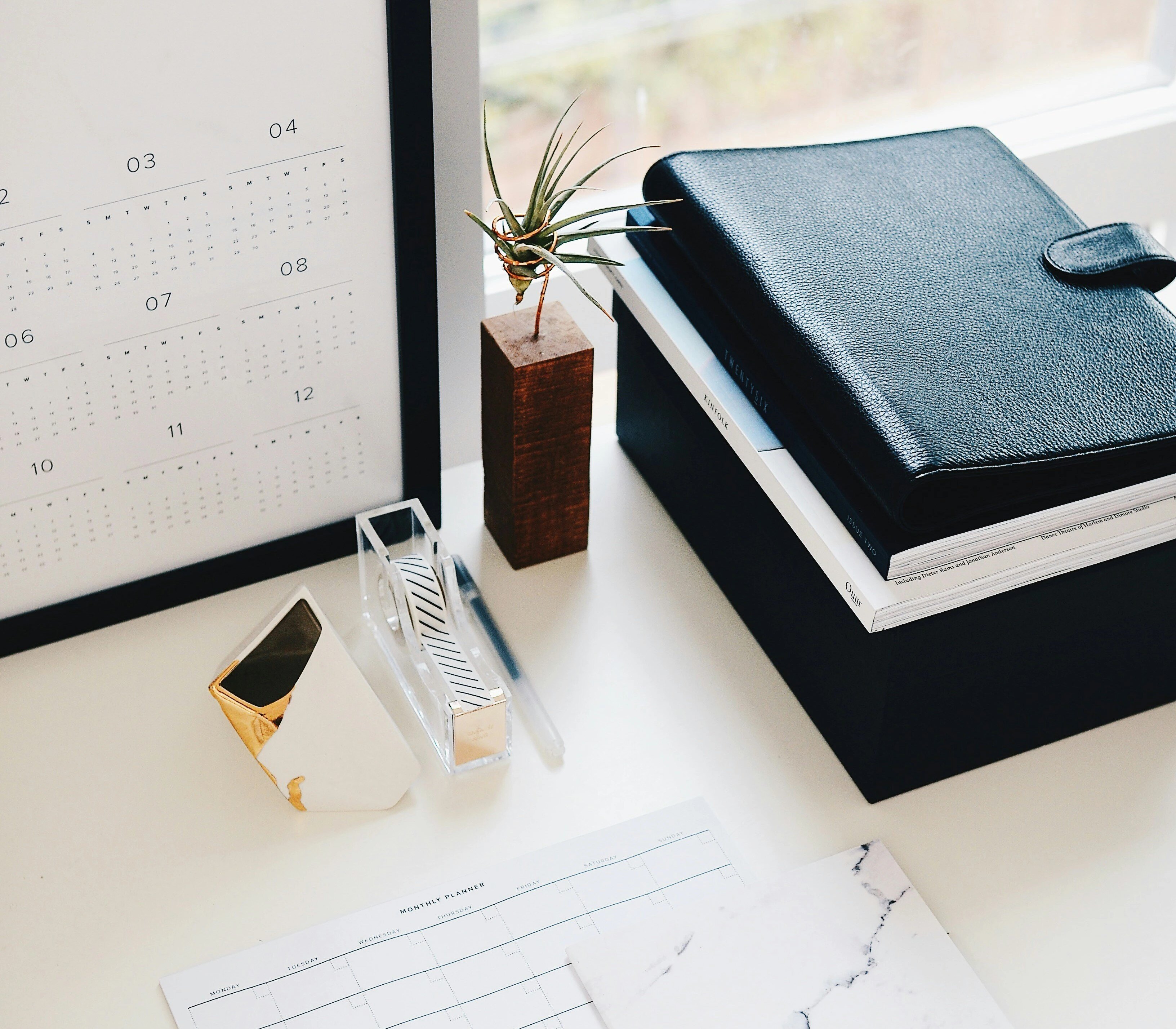 desk with notebooks and pens